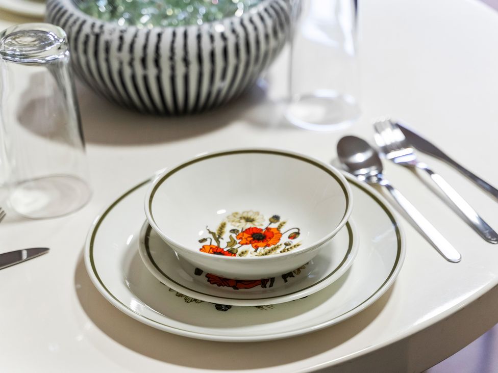 A dining table set with bowls, plates, and cutlery at Flat 34 Herbert James Close, Birmingham