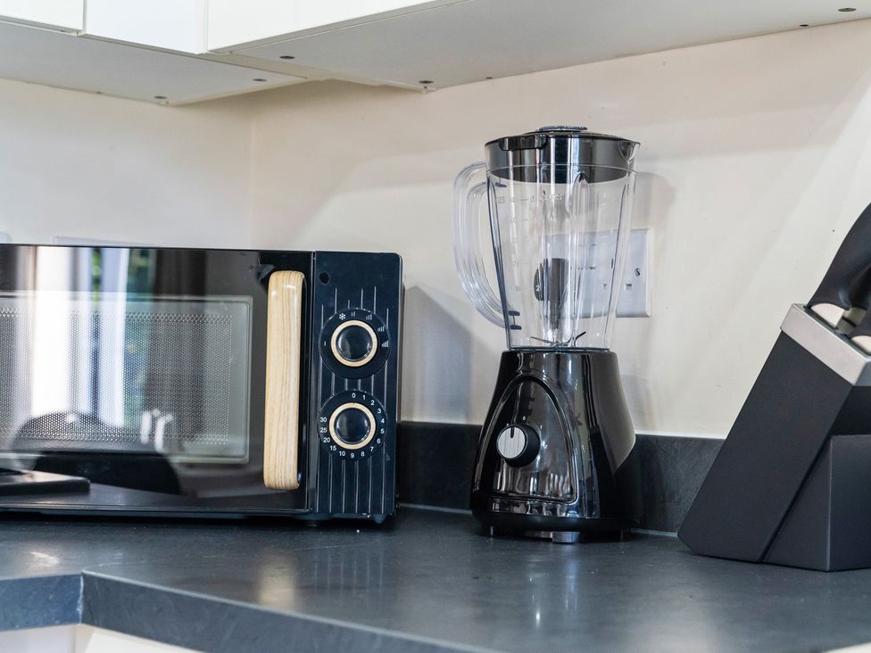 A kitchen with a microwave and a blender on the countertop at Flat 34 Herbert James Close, Birmingham