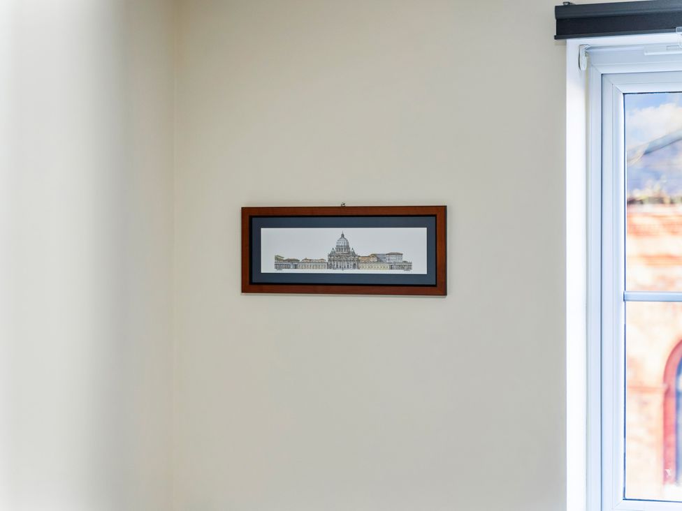 A framed artwork on the wall next to a window at Flat 34 Herbert James Close in Birmingham