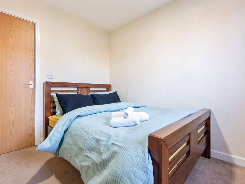 A bedroom with a bed and towels at Flat 34 Herbert James Close in Birmingham