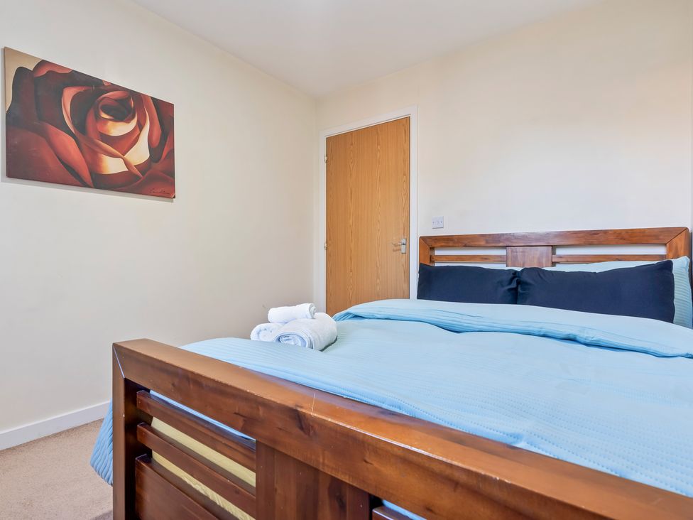 A bedroom with a bed and a painting at Flat 34 Herbert James Close, Birmingham
