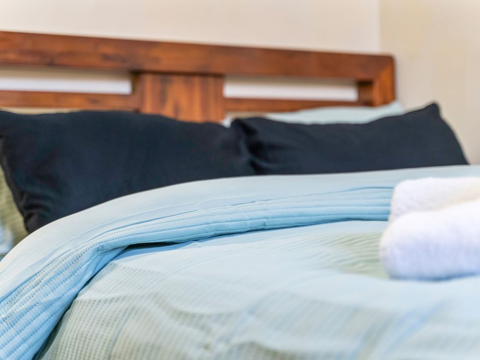 A bed with pillows and a towel at Flat 34 Herbert James Close in Birmingham