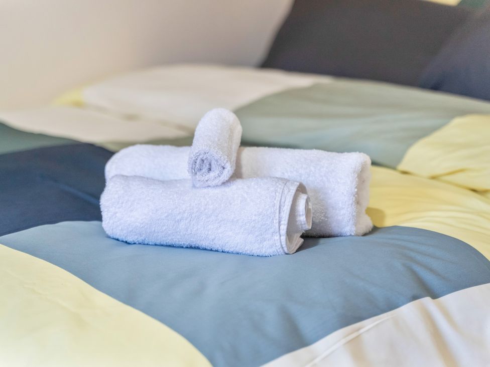 Towels arranged on a bed at Flat 34 Herbert James Close Birmingham