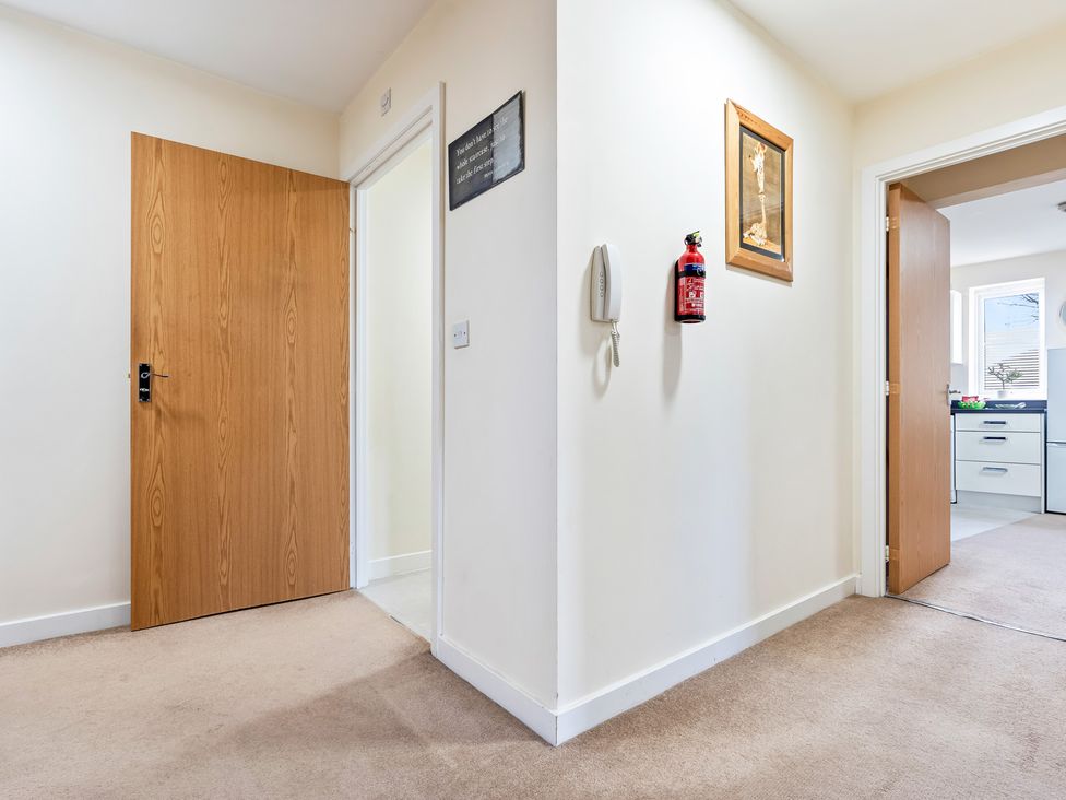 A hallway with doors and fire extinguisher at Flat 34 Herbert James Close Birmingham