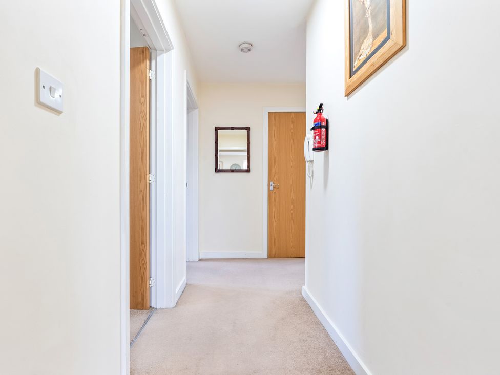 A hallway with doors and a mirror at Flat 34 Herbert James Close in Birmingham