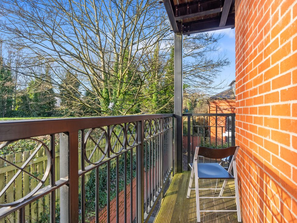 A balcony with a chair and view of trees at Flat 34 Herbert James Close in Birmingham