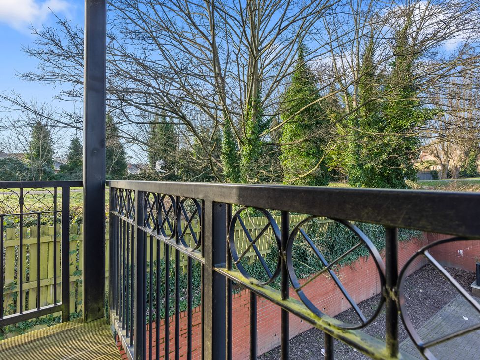 A balcony railing with a view of trees and a garden at Flat 34 Herbert James Close in Birmingham