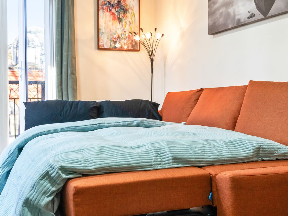 A living room with a sofa and blankets at Flat 34 Herbert James Close in Birmingham
