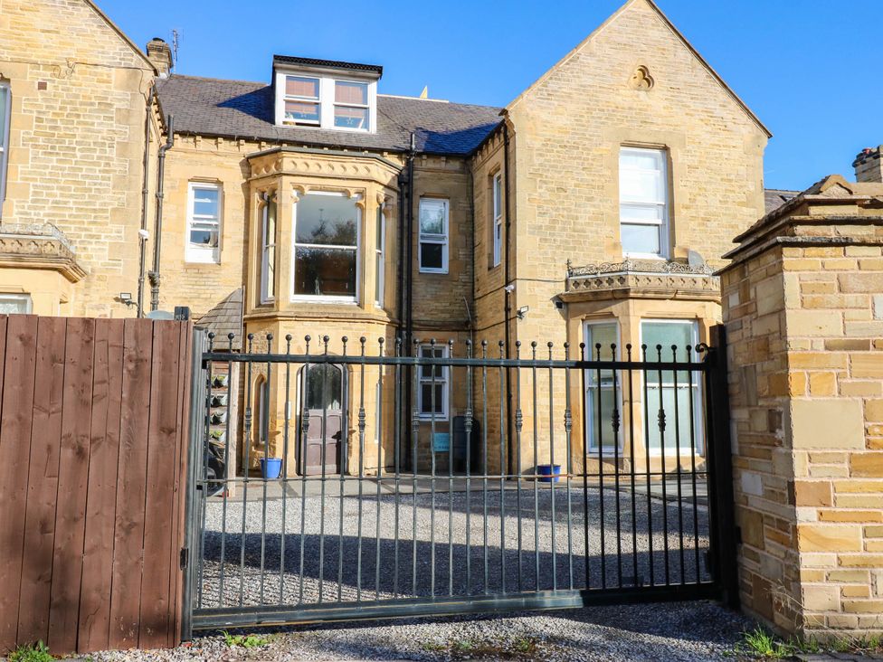 An exterior view of a building with a gate at Bishops Quarter - Barrington, Bishop Auckland