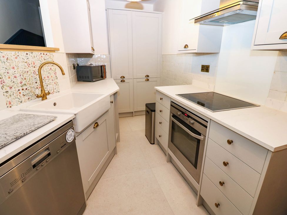 A kitchen with a stove, sink, and cabinets at Bishops Quarter - Barrington in Bishop Auckland