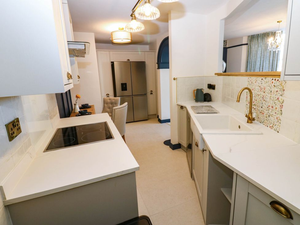 A kitchen with a sink and stovetop at Bishops Quarter - Barrington in Bishop Auckland