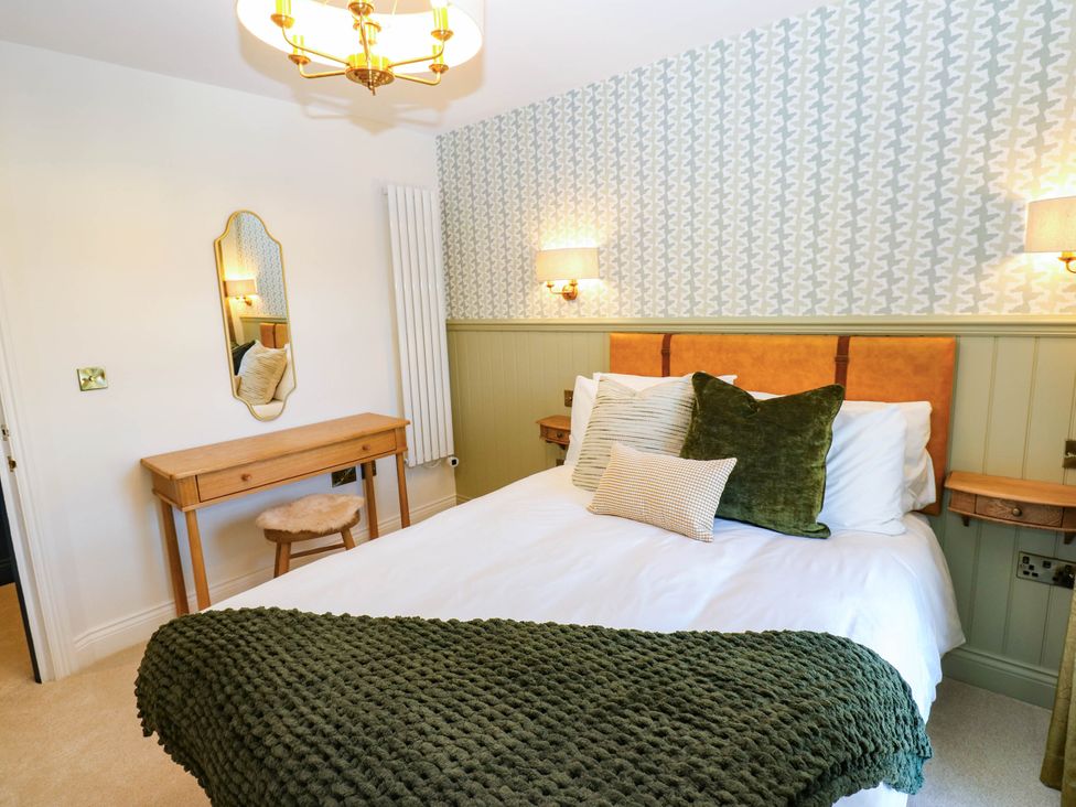 A bedroom with a bed and mirror at Bishops Quarter - Barrington in Bishop Auckland