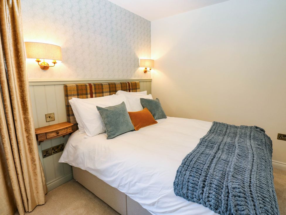 A bedroom with a bed and bedside lamps at Bishops Quarter - Barrington in Bishop Auckland