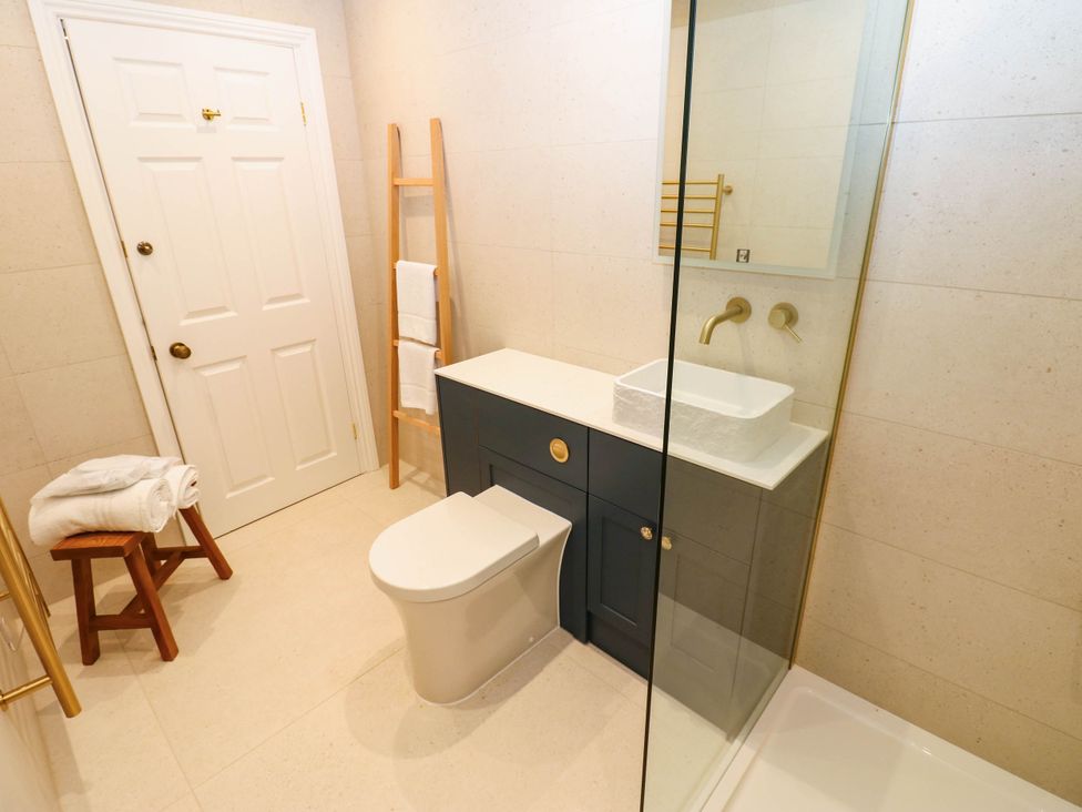 A bathroom with a sink, toilet, and towel rack at Bishops Quarter - Barrington in Bishop Auckland
