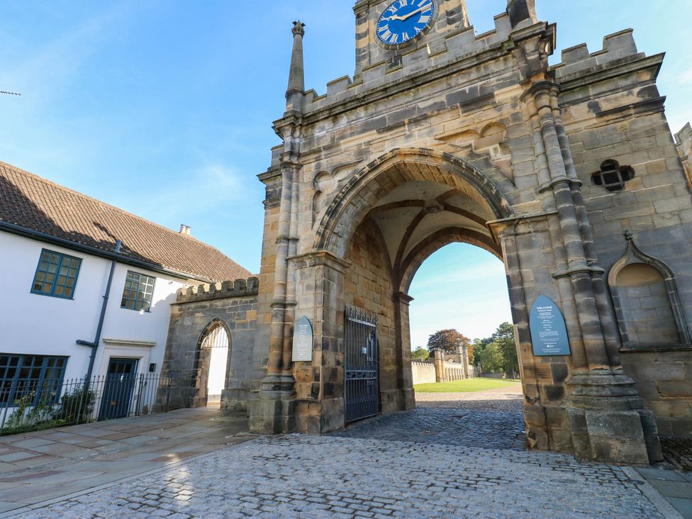 An archway with a clock and buildings at Bishops Quarter - Barrington Bishop Auckland