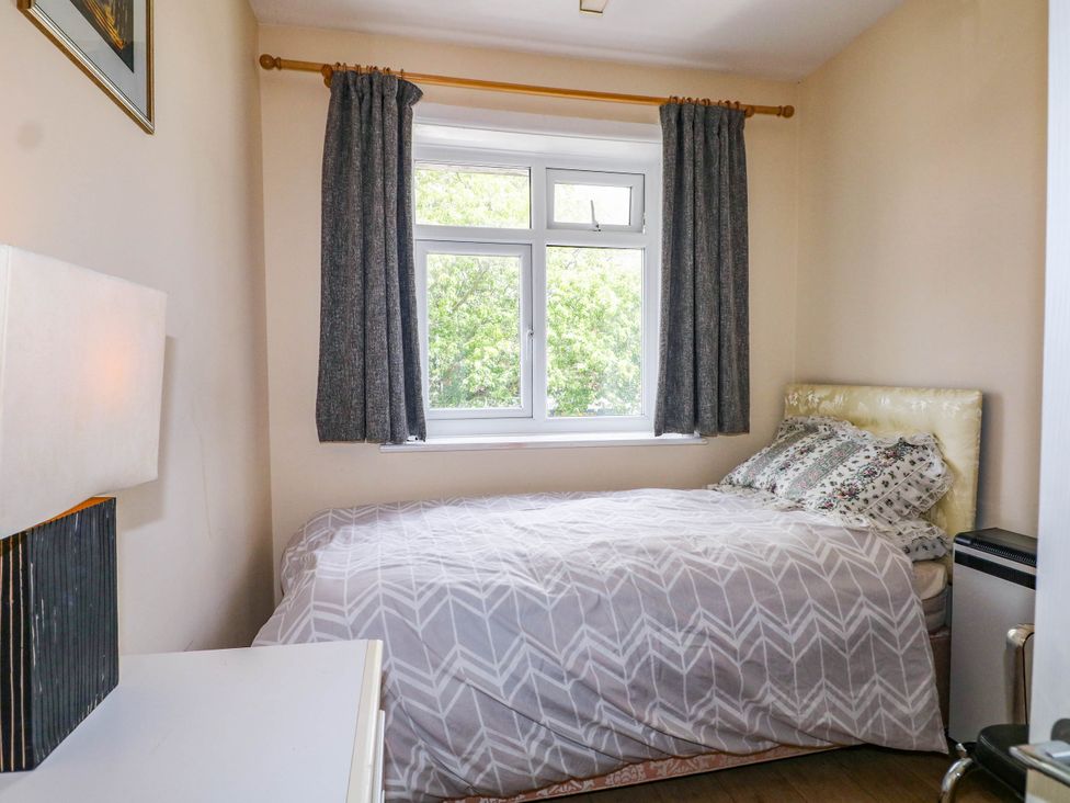 A bedroom with a bed and window at 90 A Station Road New Milton