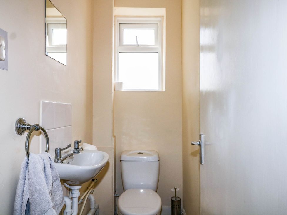 A bathroom with a toilet and sink at 90 A Station Road New Milton