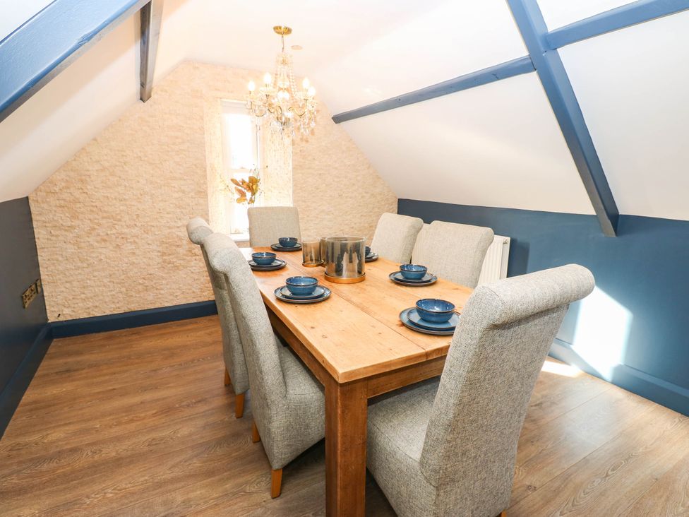 A dining room with a wooden table and chairs at Bishops Quarter - Flambard, Bishop Auckland