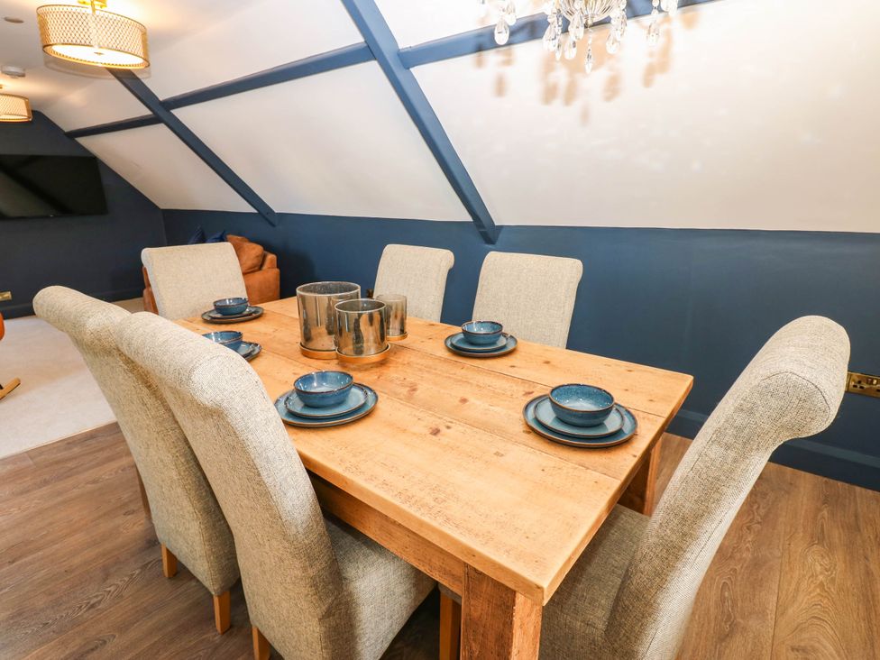 A dining room with a wooden table and chairs at Bishops Quarter - Flambard, Bishop Auckland