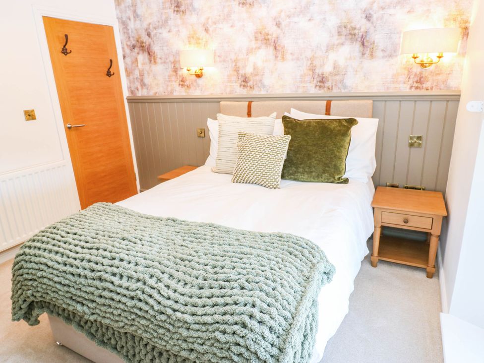 A bedroom with a bed and nightstand at Bishops Quarter - Flambard in Bishop Auckland