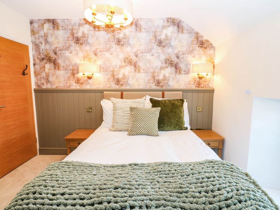 A bedroom with a bed and lamps at Bishops Quarter - Flambard in Bishop Auckland