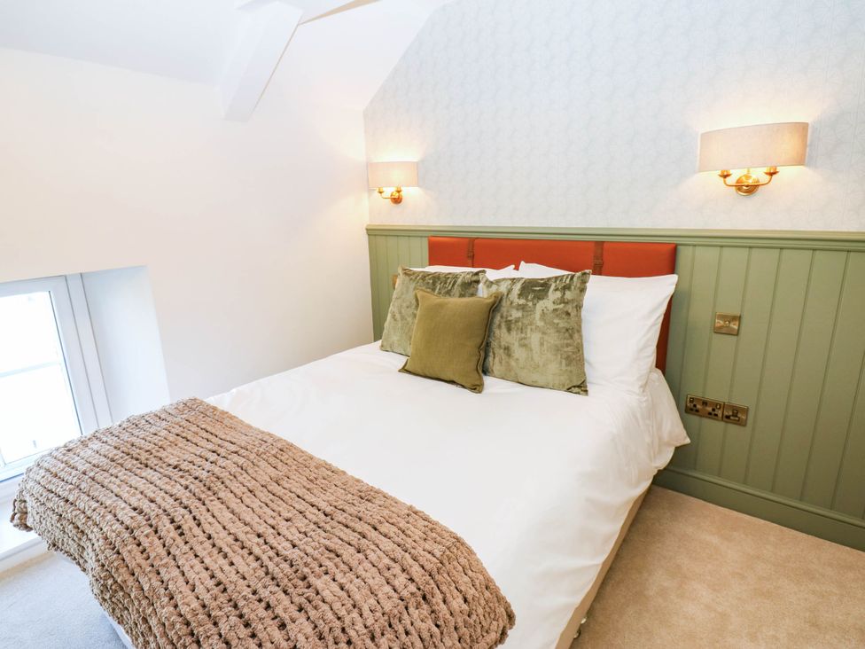 A bedroom with a bed and pillows at Bishops Quarter - Flambard in Bishop Auckland