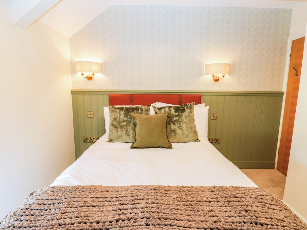 A bedroom with a bed and bedside lamps at Bishops Quarter - Flambard in Bishop Auckland