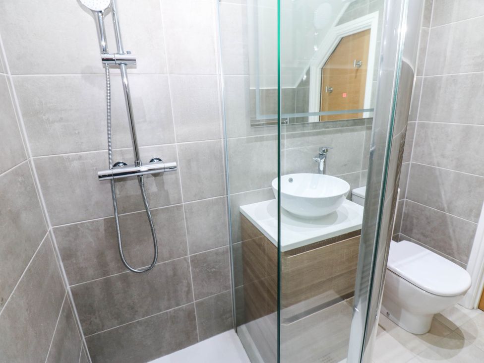 A bathroom with a shower, washbasin, and toilet at Bishops Quarter - Flambard in Bishop Auckland