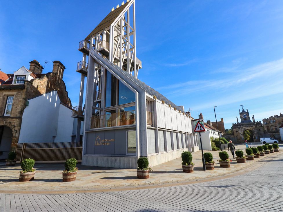 An outdoor view of Auckland Tower with planters at Bishops Quarter - Flambard, Bishop Auckland