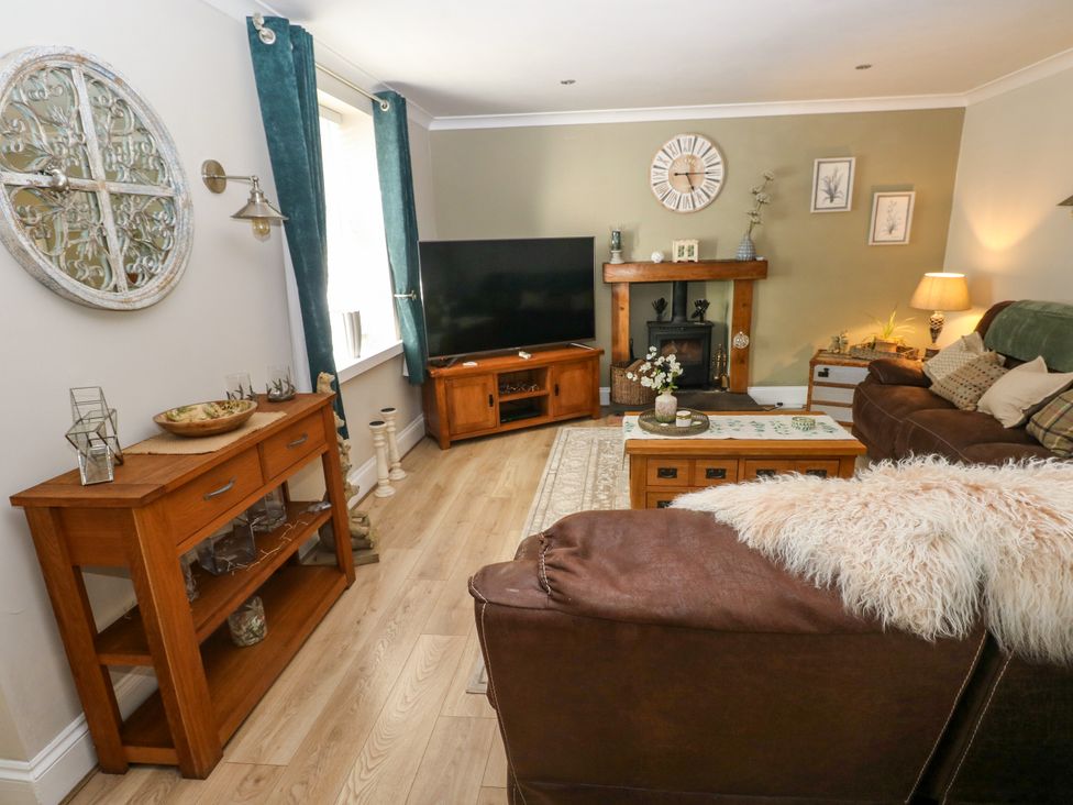 A living room with a sofa and television at St.Twynells Farm in Pembroke