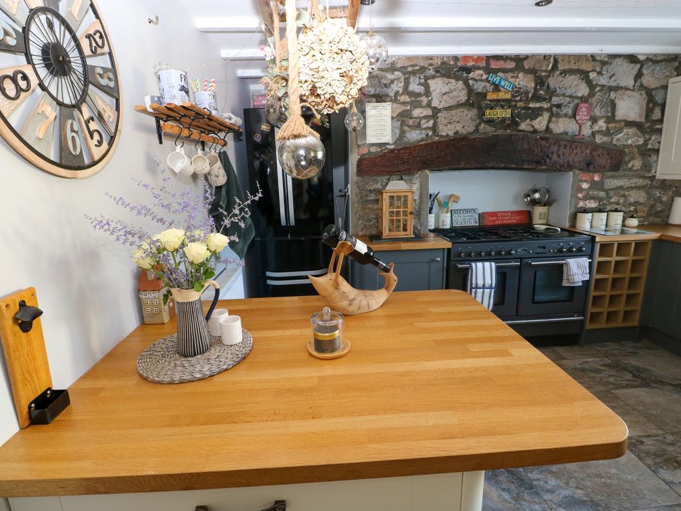 A kitchen with a countertop and kitchen appliances at St.Twynells Farm in Pembroke