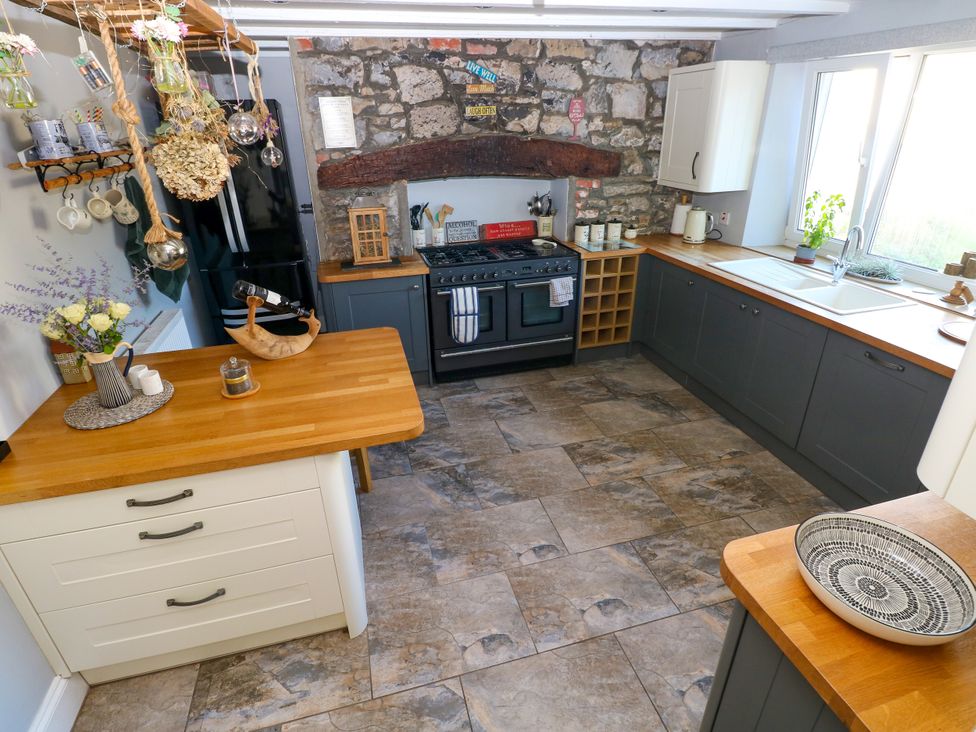 A kitchen with a stove and sink at St.Twynells Farm in Pembroke