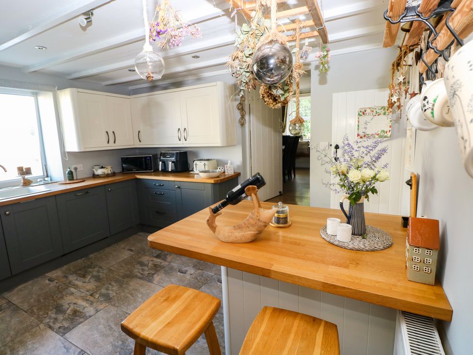 A kitchen with countertop, cabinets, and decorative items at St.Twynells Farm in Pembroke