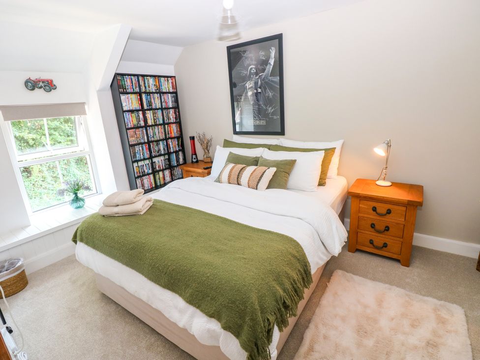 A bedroom with a bed and a bookshelf at St.Twynells Farm in Pembroke