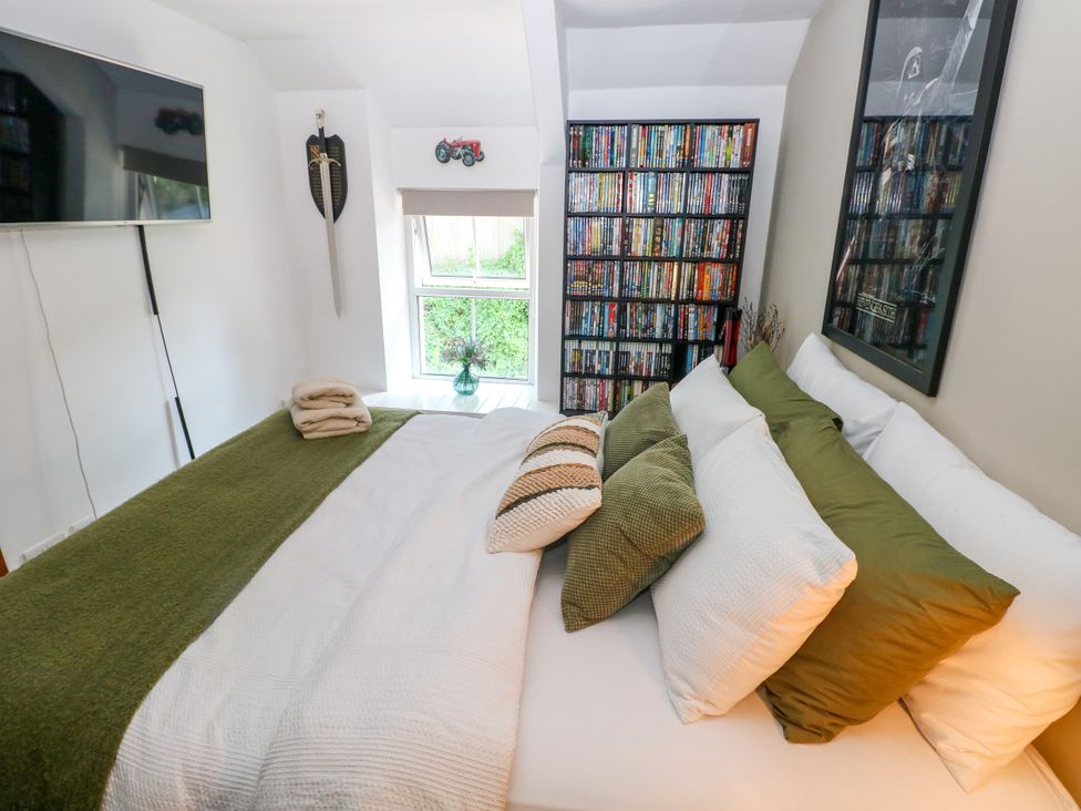 A bedroom with a bed and a television at St.Twynells Farm in Pembroke