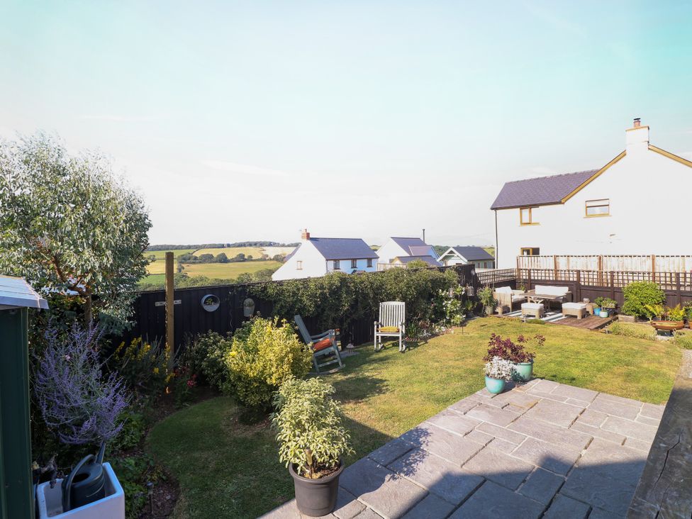 A garden with furniture and plants at St.Twynells Farm in Pembroke