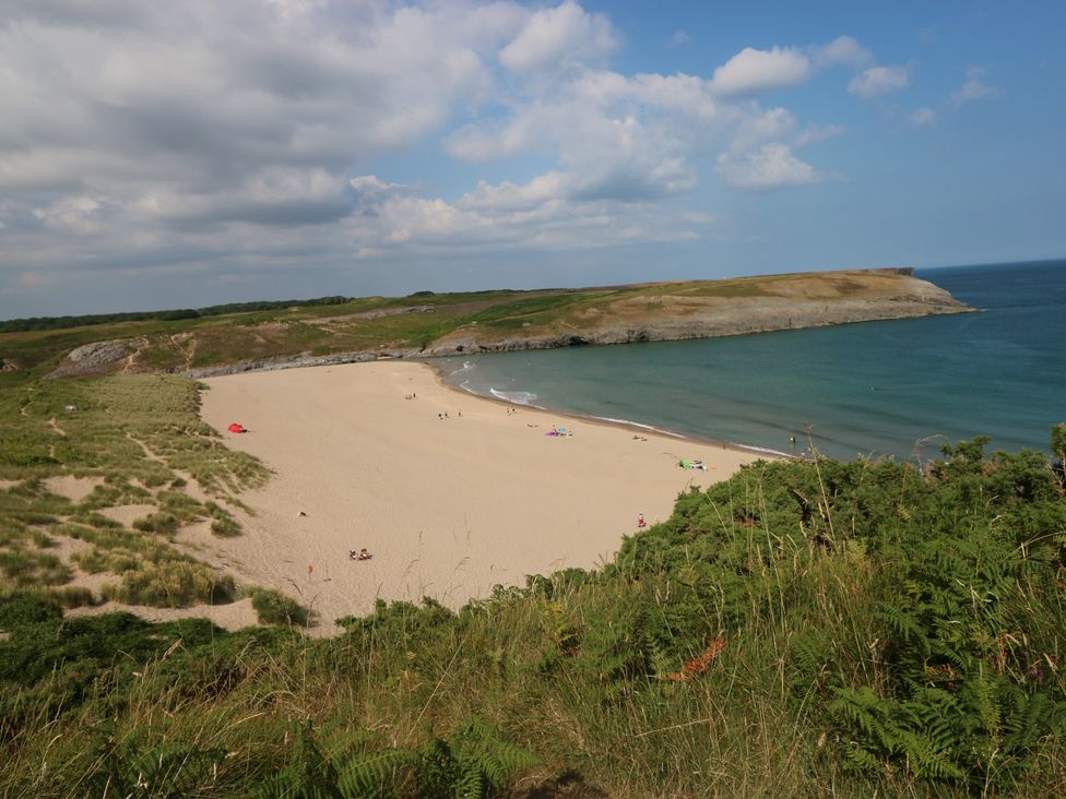 A beach with sand and water at St.Twynells Farm in Pembroke