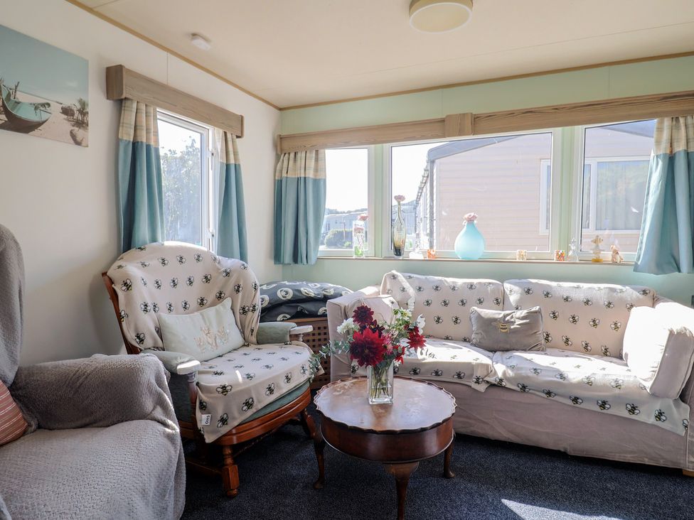 A living room with sofa and coffee table at Beech Walk 3 Sandy Bay, Exmouth