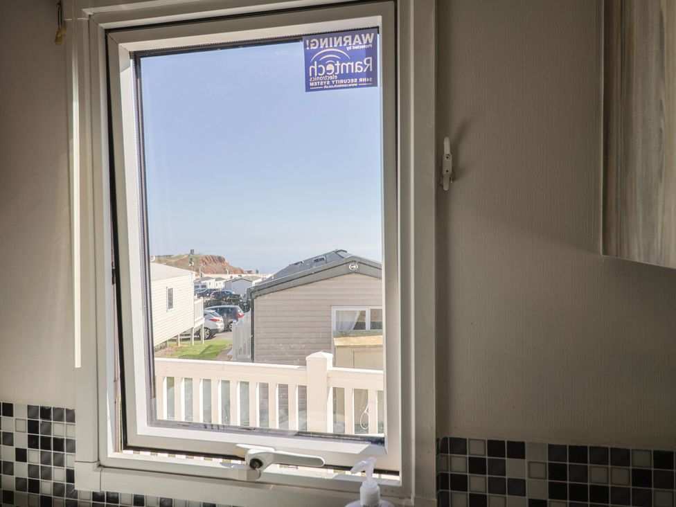 A window view showing houses and ocean at Beech Walk 3 Sandy Bay, Exmouth
