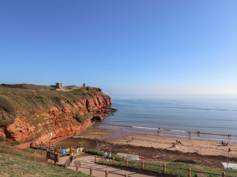 A beach with people near the ocean at Beech Walk 3 Sandy Bay, Exmouth