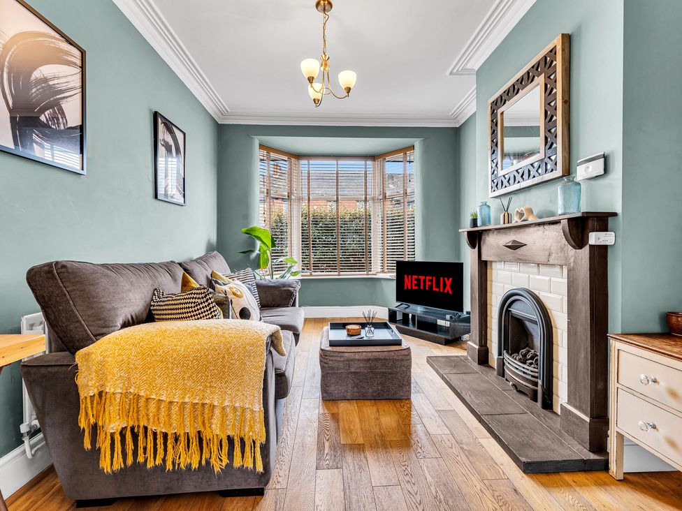 A living room with a sofa and television at Stoke Townhouse in Stoke-on-Trent