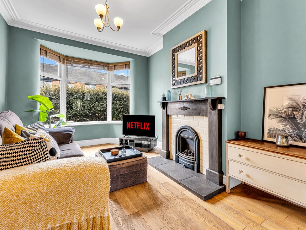 A living room with a television and sofa at Stoke Townhouse in Stoke-on-Trent