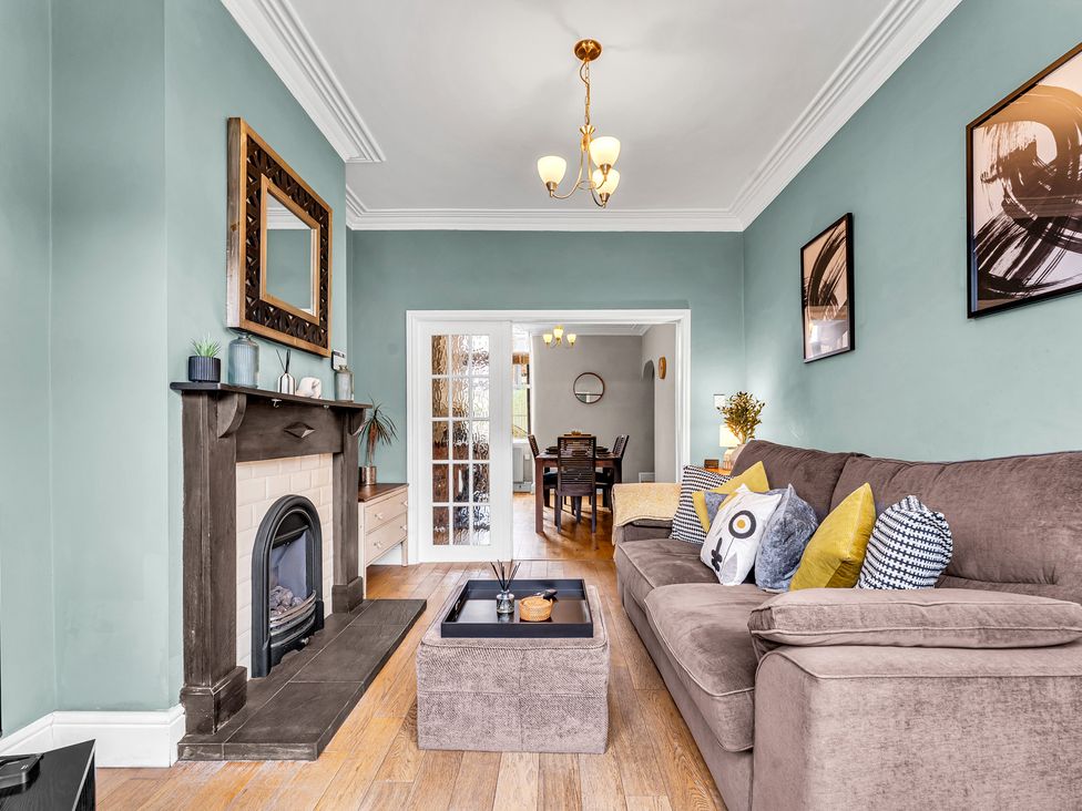 A living room with a fireplace and sofa at Stoke Townhouse in Stoke-on-Trent