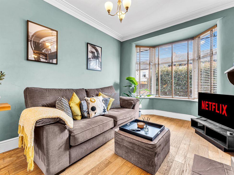 A living room with a sofa and television at Stoke Townhouse in Stoke-on-Trent