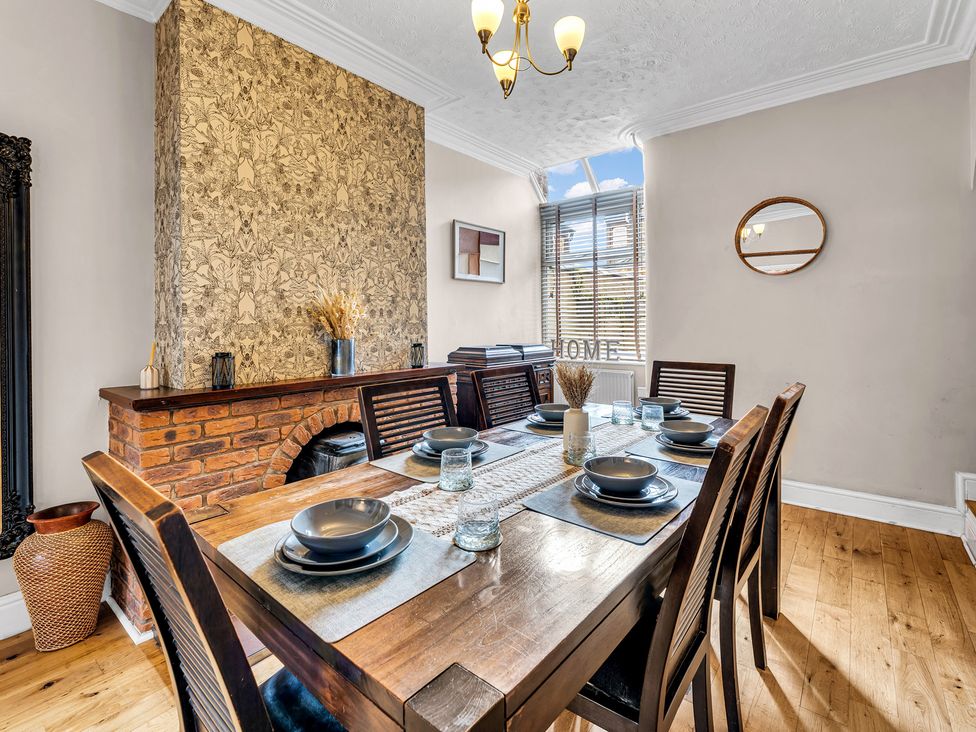 A dining room with a table set for meals at Stoke Townhouse in Stoke-on-Trent