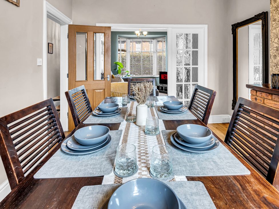 A dining room with a table set for meals at Stoke Townhouse in Stoke-on-Trent