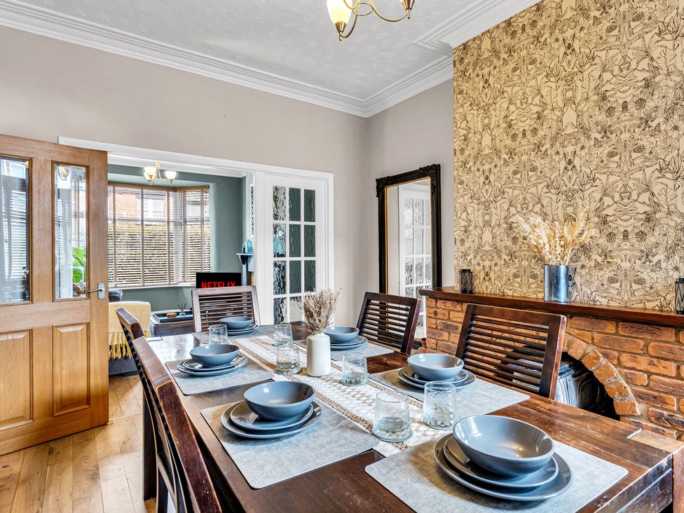 A dining room with a table set for meals at Stoke Townhouse in Stoke-on-Trent