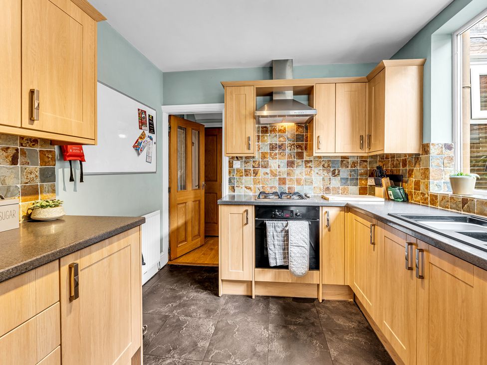 A kitchen with cabinetry and appliances at Stoke Townhouse in Stoke-on-Trent