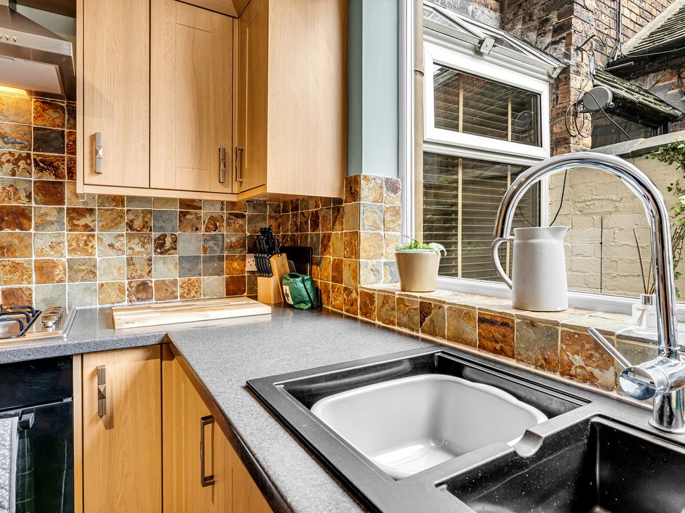 A kitchen with cabinets and countertop at Stoke Townhouse in Stoke-on-Trent