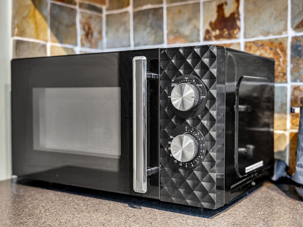 A microwave on a countertop at Stoke Townhouse in Stoke-on-Trent